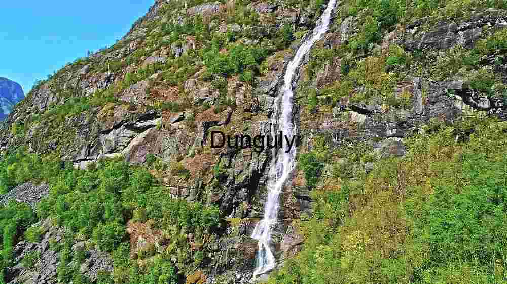 Uncover Earth's stunning landscapes. Experience breathtaking worldwide views (70) Majestic Waterfall Cascading Down a Rocky Cliffside