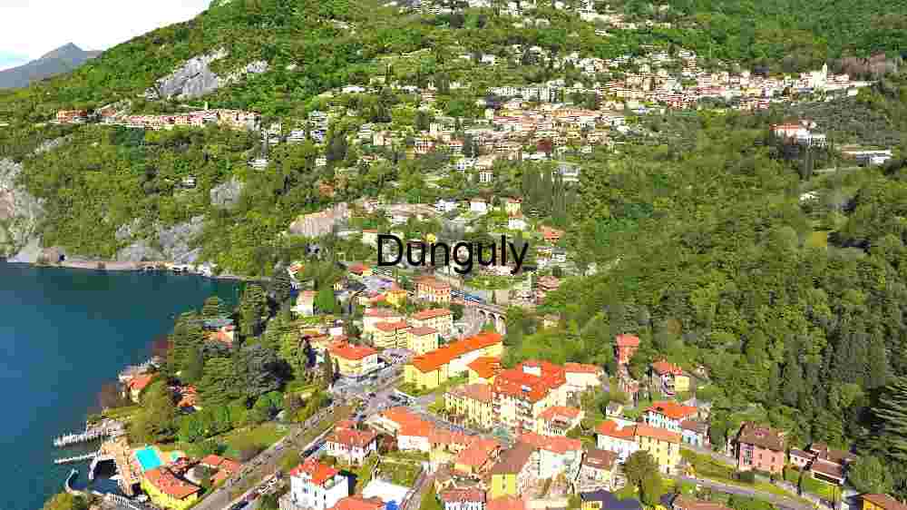 Capture the ethereal beauty of our planet from above through the lens of aerial photography, revealing the untouched splendor of its natural landscapes (44) Aerial View of a Lakeside Town Nestled in Lush Greenery