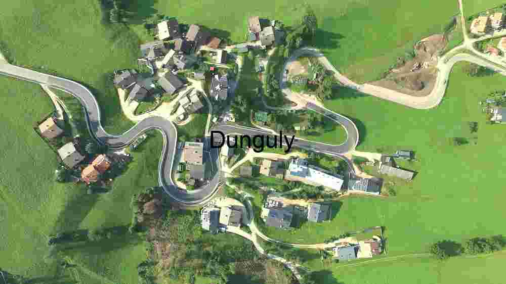 Capture the ethereal beauty of our planet from above through the lens of aerial photography, revealing the untouched splendor of its natural landscapes (60) Serpentine Roads in a Lush Green Village