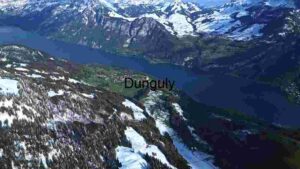 At Home Alpine Serenity: Aerial View of a Snow-Capped Mountain Village by the Lake