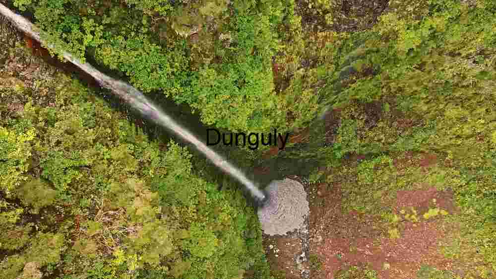 Incredible global spots nature wonders, cultural gems, and breathtaking vistas (65) Aerial View of a Secluded Waterfall in Lush Greenery