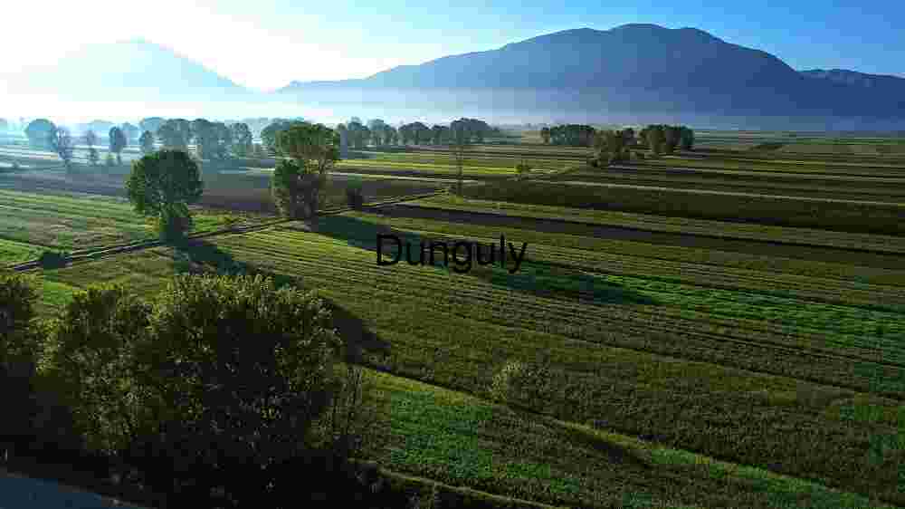 Incredible global spots nature wonders, cultural gems, and breathtaking vistas (82) Serene Agricultural Landscape with Mountain Backdrop