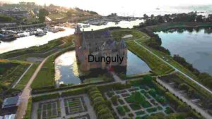 At Home Aerial View of a Majestic Castle Surrounded by Water and Greenery