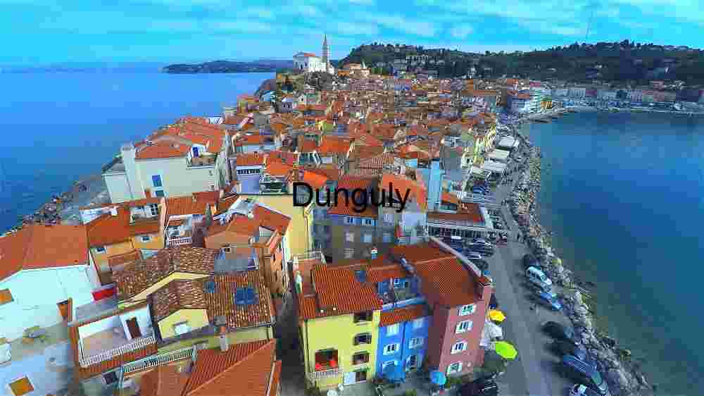 Unveiling the Celestial Fabric Embracing the Abundance of Diversity Across Earth's Expansive Terrains (34) Picturesque Coastal Town with Terracotta Roofs and Serene Blue Sea