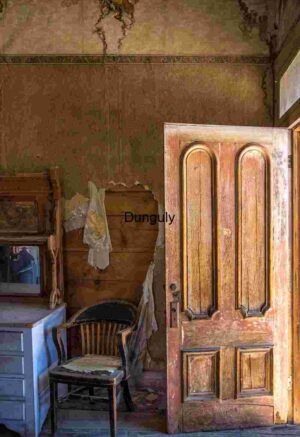 Abandoned Room with Open Door and Vintage Furniture