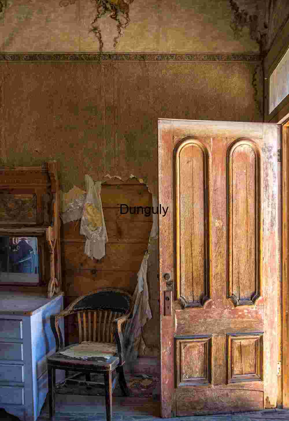 Door_and_chair_Bodie_State_Park_California Abandoned Room with Open Door and Vintage Furniture