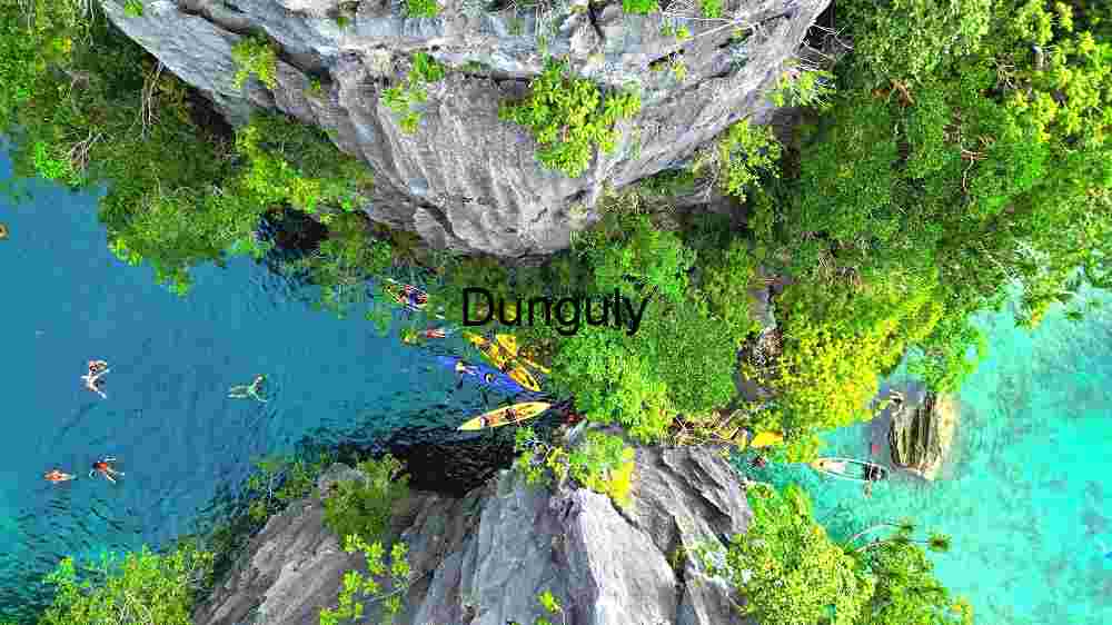 Experience Earth's natural splendor from above. Explore its innate beauty through professional capture (67) Aerial View of Kayakers and Swimmers in a Tropical Lagoon