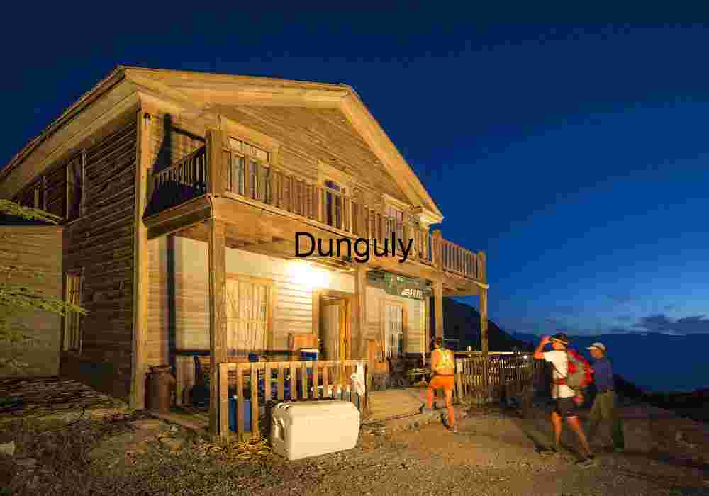 Badwater runners check in at the American Hotel Rustic Lodge at Dusk with Hikers in Outdoor Gear
