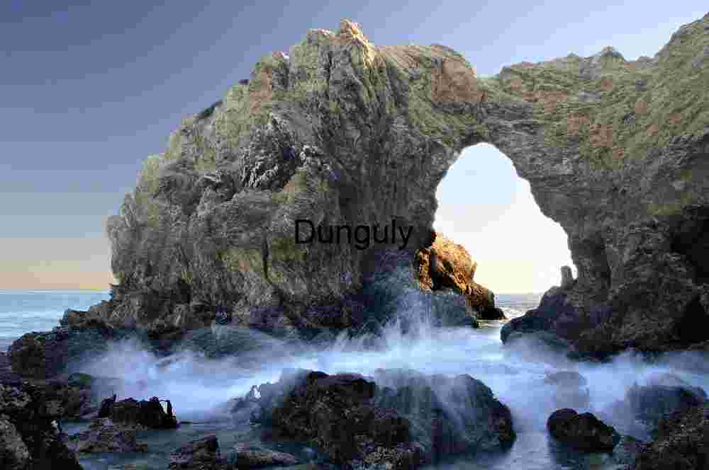 Corona del Mar sea arch - low tide and breaking wave Coastal Rock Arch with Ocean Waves Crashing Below