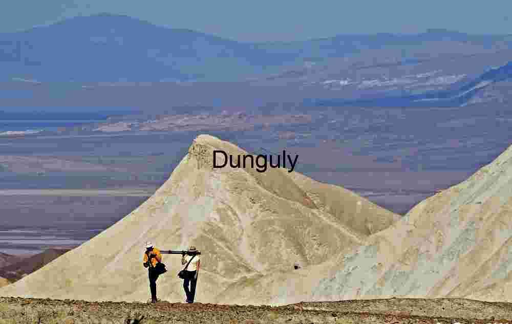 Death Valley - Photographers in 20 Mule Team Canyon Traversing the Vastness: Hikers Amid Desert Peaks
