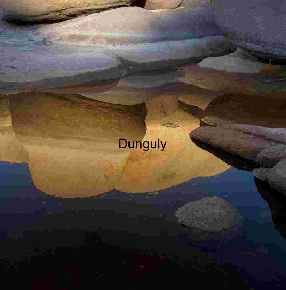 Golden reflections, Barker Dam - Joshua Tree National Park Erosion Echoes: Reflected Rock Forms in Desert Stillness