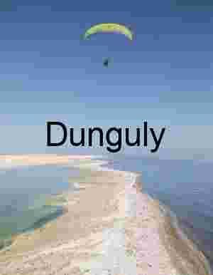 Paraglider Soaring Above Desert Peninsula Between Contrasting Waters