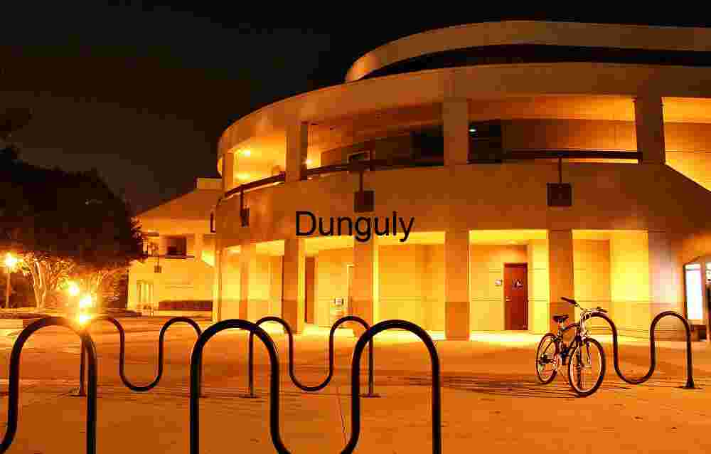 Physical Sciences Lecture Hall, UCI Architectural Atmosphere Modern Circular Building Illuminated at Night with Warm Orange Glow