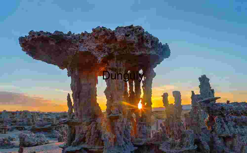 Sand tufa backlit sunstar at dawn, Mono Lake Tufa Towers Silhouetted at Sunset Over Mono Lake- close