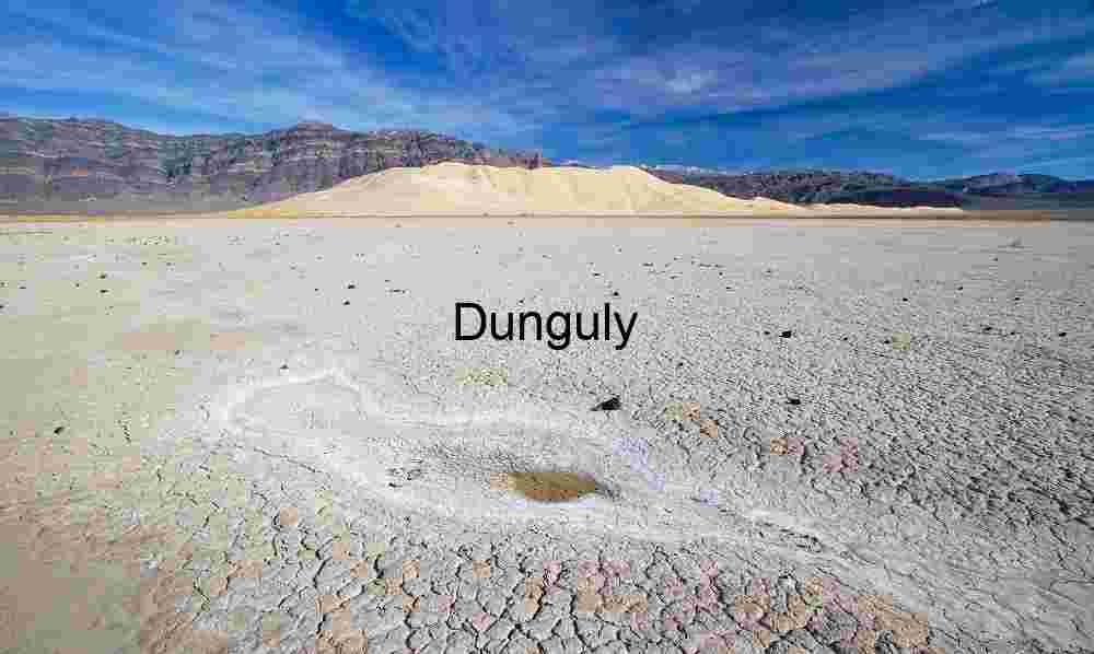The last drop of water, Remains of a rainwater pool in the playa by Eureka Dunes, Death Valley National Park Salt Memory: Cracked Earth and Dunes Beneath a Blue Horizon