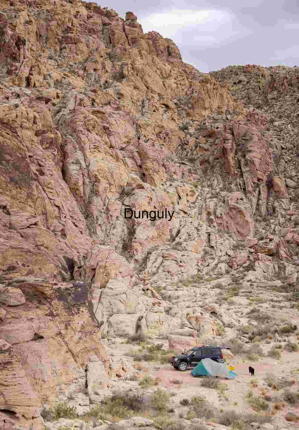Campsite by sandstone cliffs; Glowing Sandstone Pocket: Desert Rock Canyon Warmth | Campsite by sandstone cliffs
