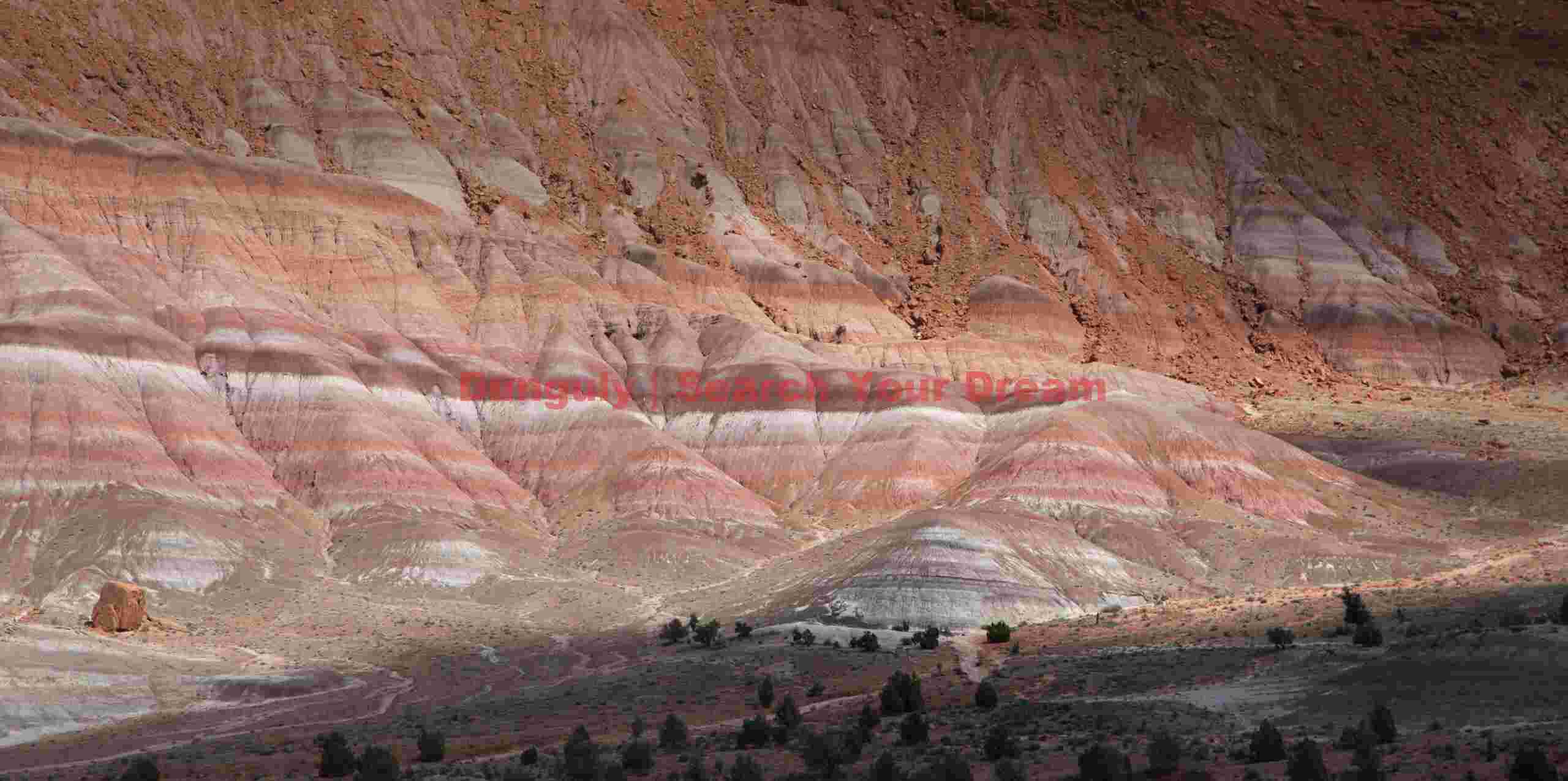 Dappled light on bentonite badlands; Old Pareah Townsite, Utah Dappled Shadows Dance Across Colorful Badlands
