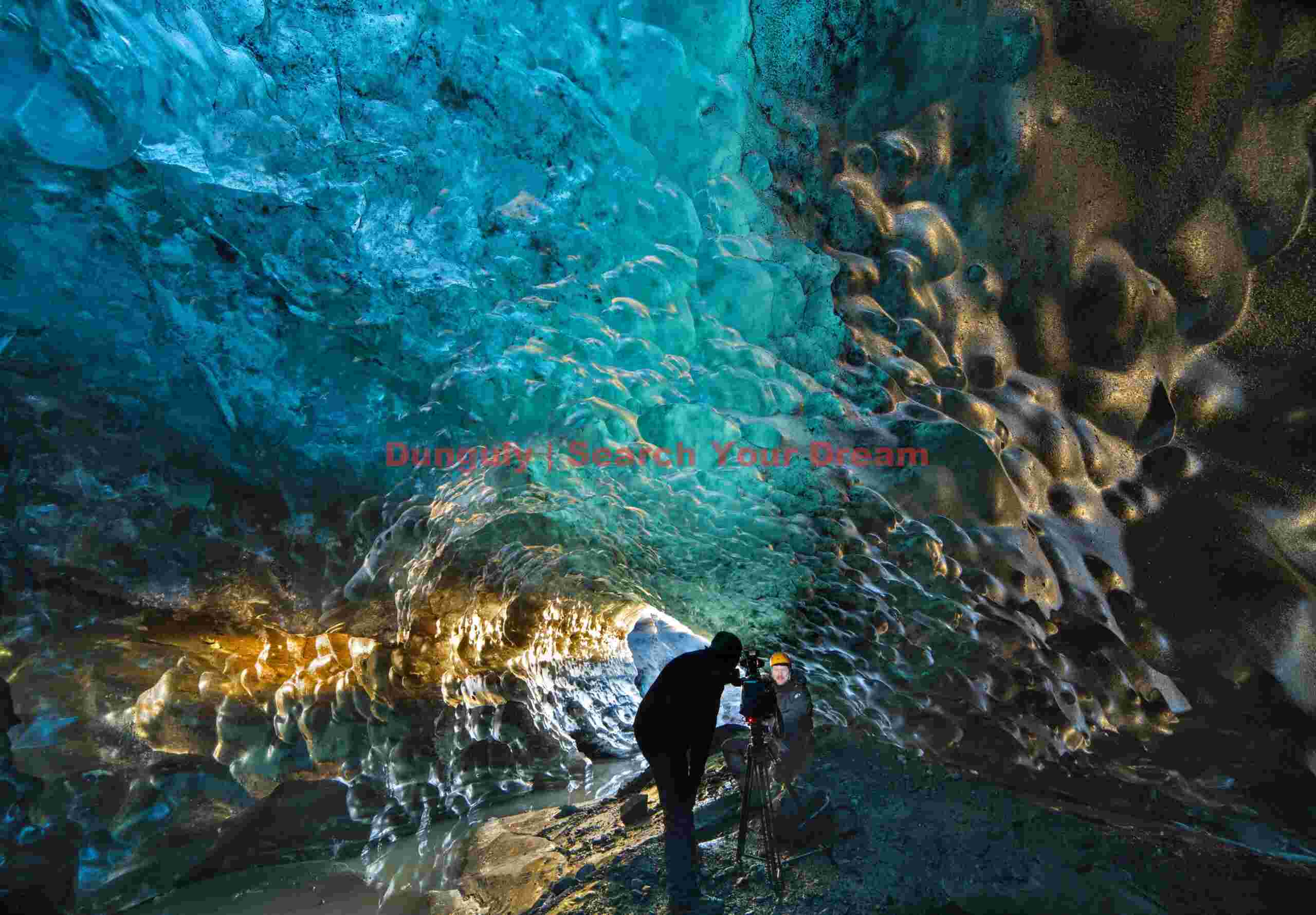 Filming in the Golden ice cave, Vatnajokull, Iceland Glacial Ice Formation at Filming in the Golden ice cave, Vatnajokull, Iceland