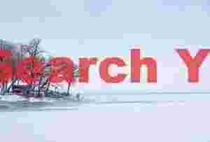 Lone figure by frozen lake in near whiteout