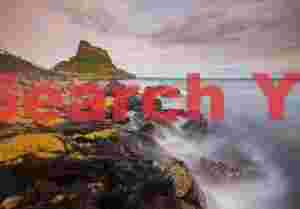 Northumbria; Lindisfarne castle and yellow lichen rocks