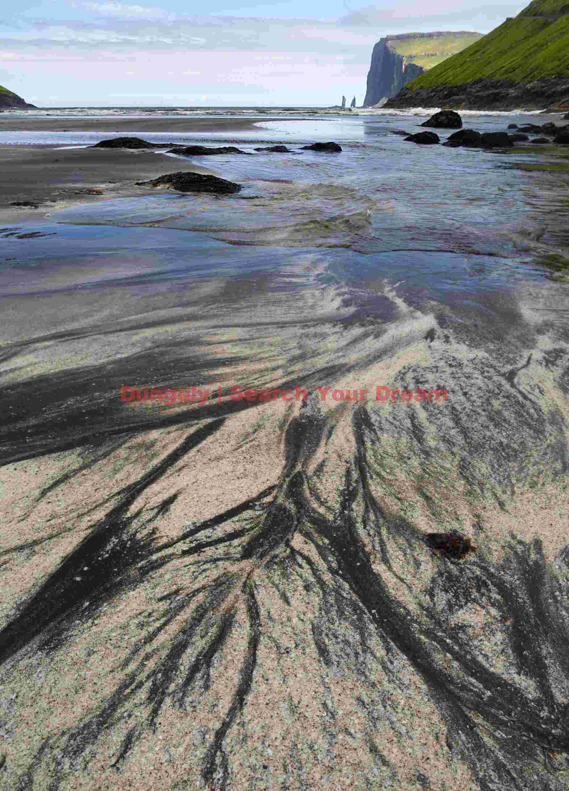 Sand patterns with distant view of Risin and Kellingin sea stacks; Faroe Islands Sand patterns with distant view of Risin and Kellingin sea stacks