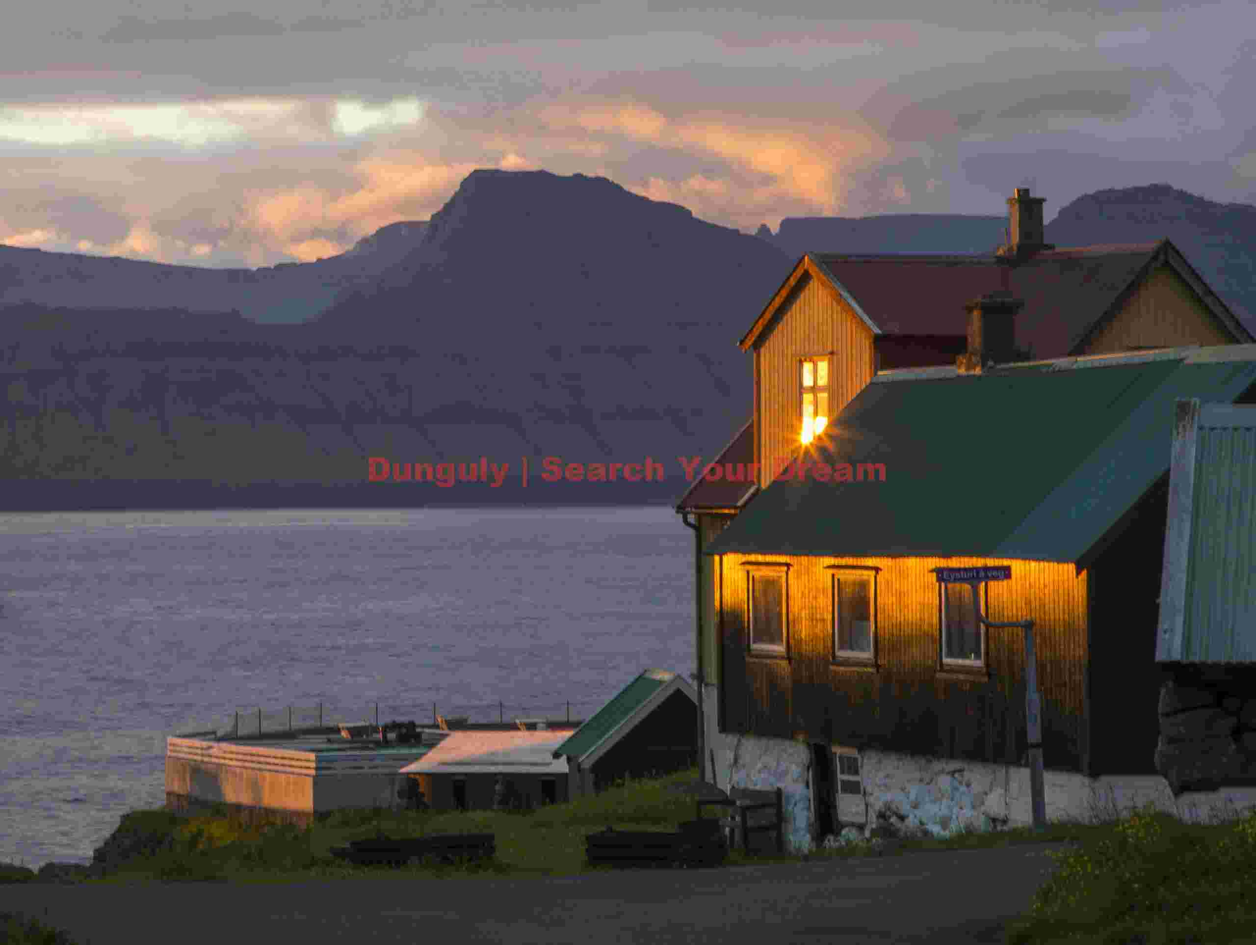 Sunrise reflection in window; Gjógv, Faroe Islands Sunrise reflection in window