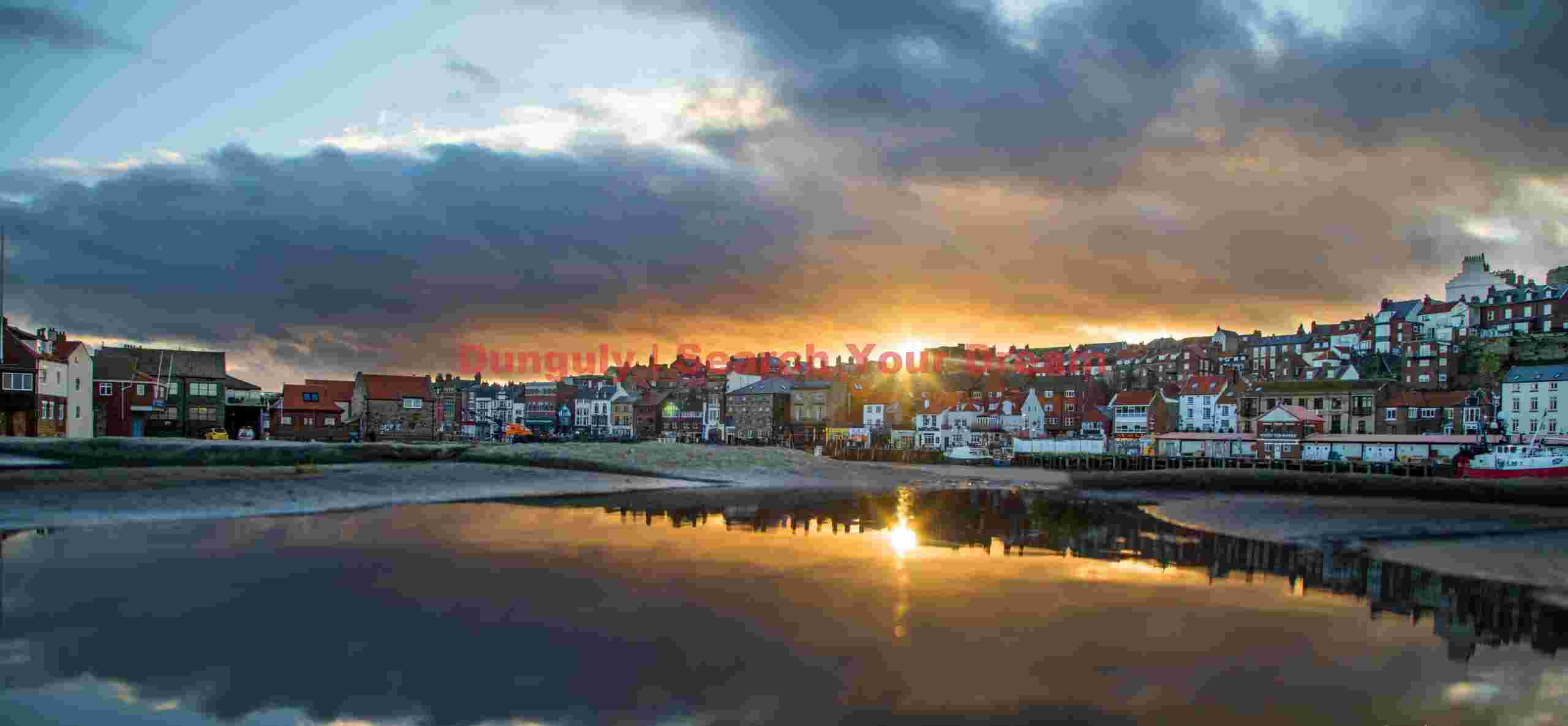 Sunset reflection in an infinity rain puddle; Whitby, Yorkshire Sunset reflection in an infinity rain puddle