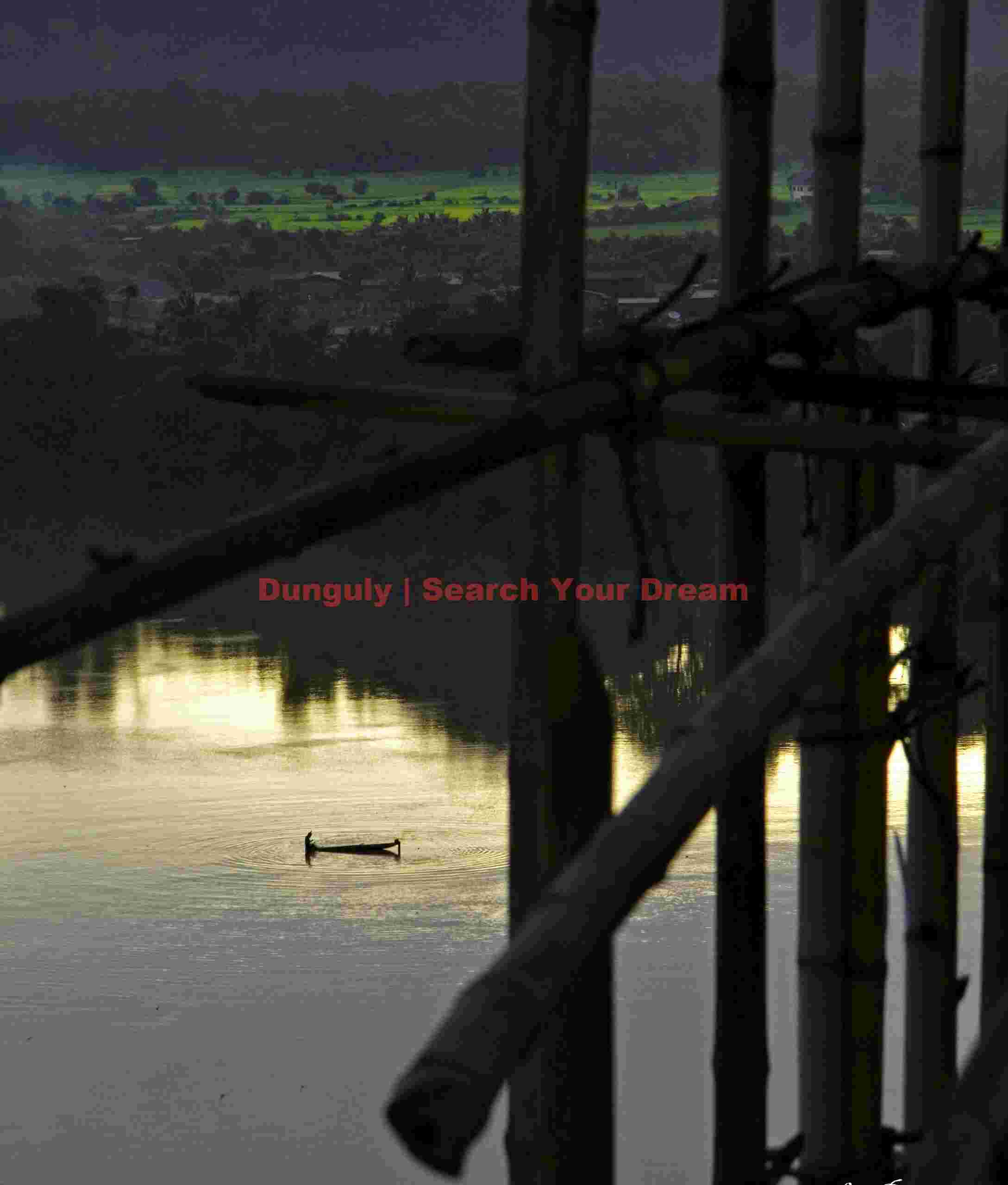 Boat on Mekong River through construction scaffold; Champasak Palace Hotel, Laos Boat on Mekong River through construction scaffold