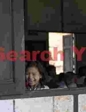 Burmese schoolgirl at window corner