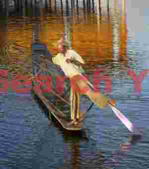 Leg-rowing fisherman and golden reflections