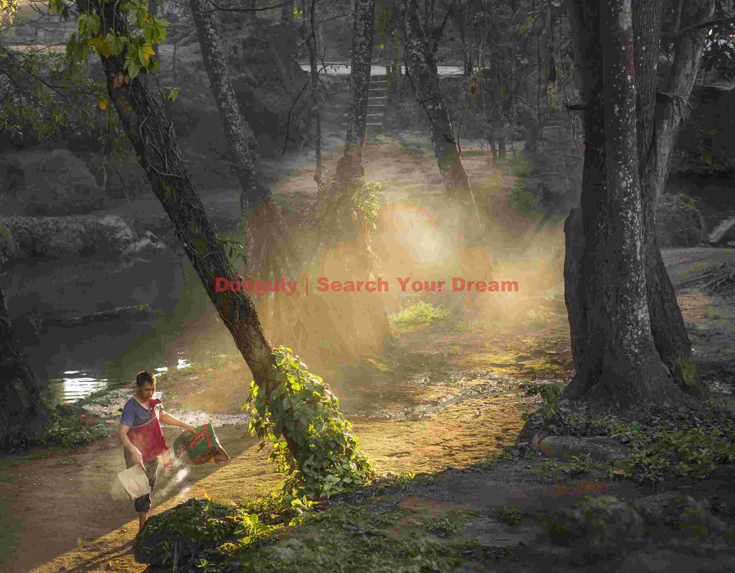 Man clearing and burning leaves and trash on riverbank; Burma Man clearing and burning leaves and trash on riverbank