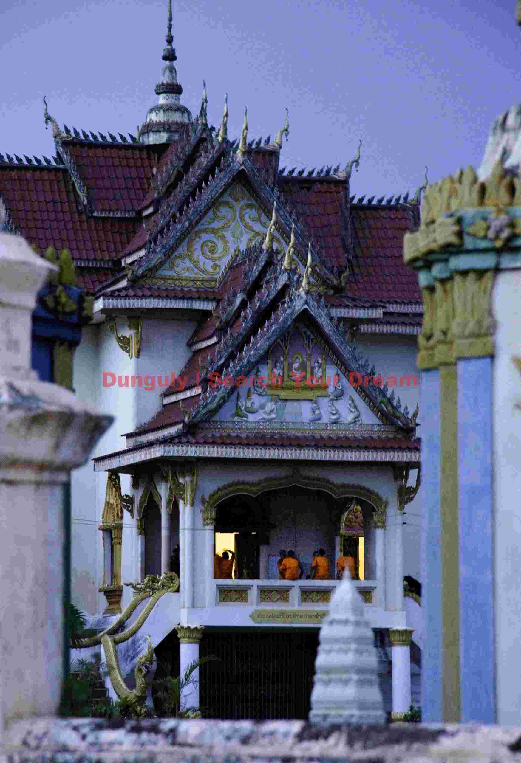 Monks gathering for evening prayers ; Champasak, Laos Monks gathering for evening prayers