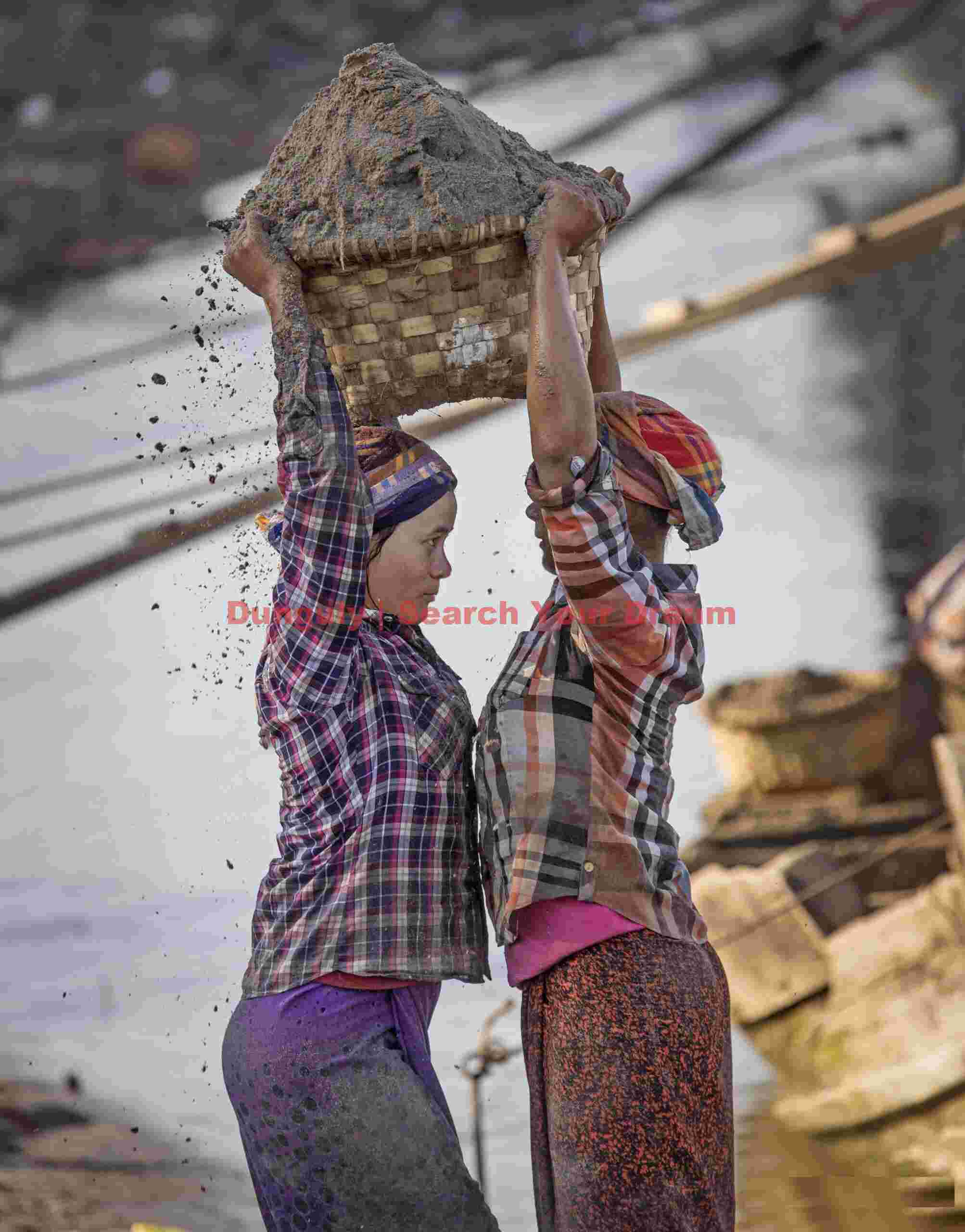 Transferring a sand basket; Mandalay, Burma Transferring a sand basket
