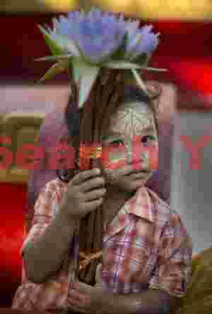 Young girl with blue flower