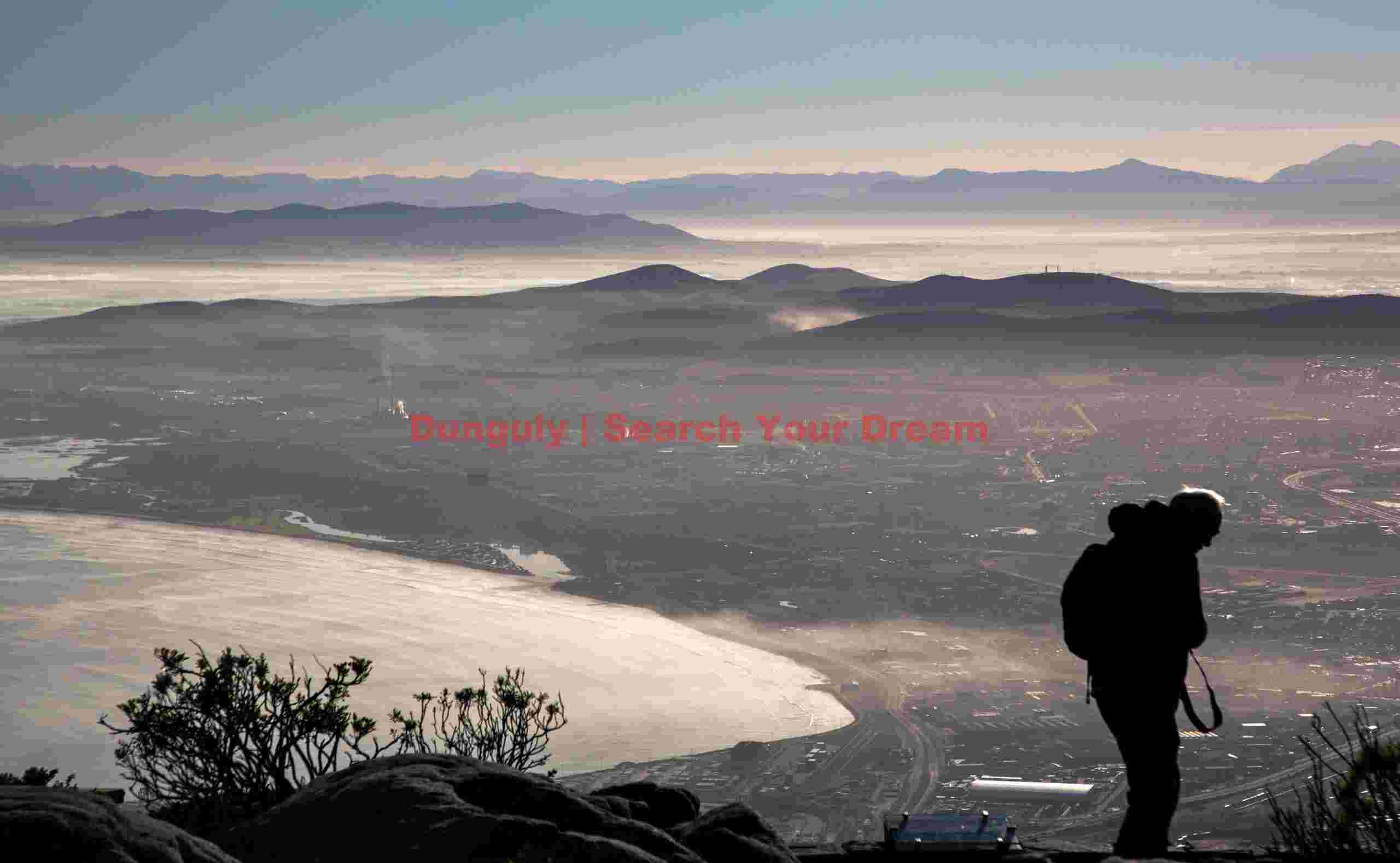 Hiker at the edge of Table Mountain Hiker at the edge of Table Mountain