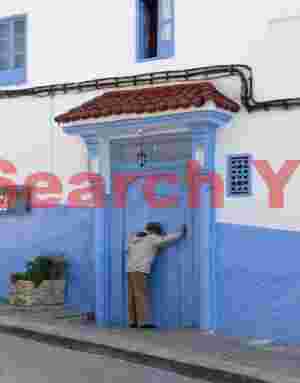 Man at blue door