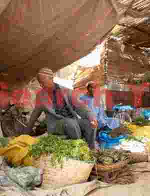 Produce seller under awning