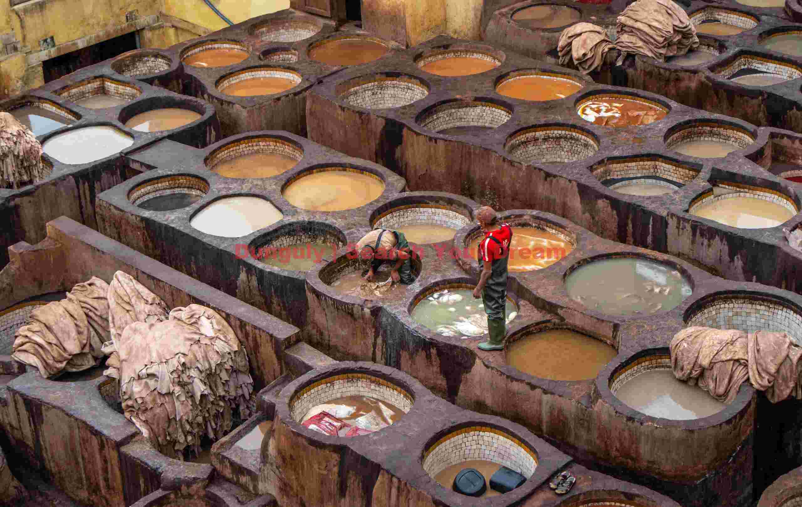 Tanners in the dyeing tanks, Chouara tannery;; Fez, Morocco Tanners in the dyeing tanks, Chouara tannery