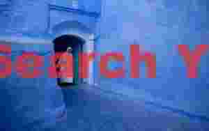 Woman in white in blue entranceway