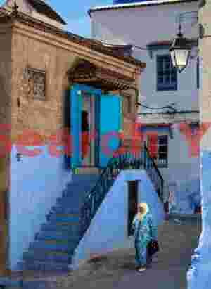 Woman passing by blue steps