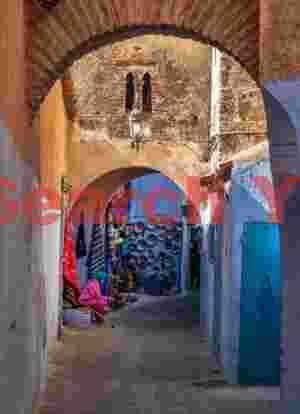 Woman sitting under archways