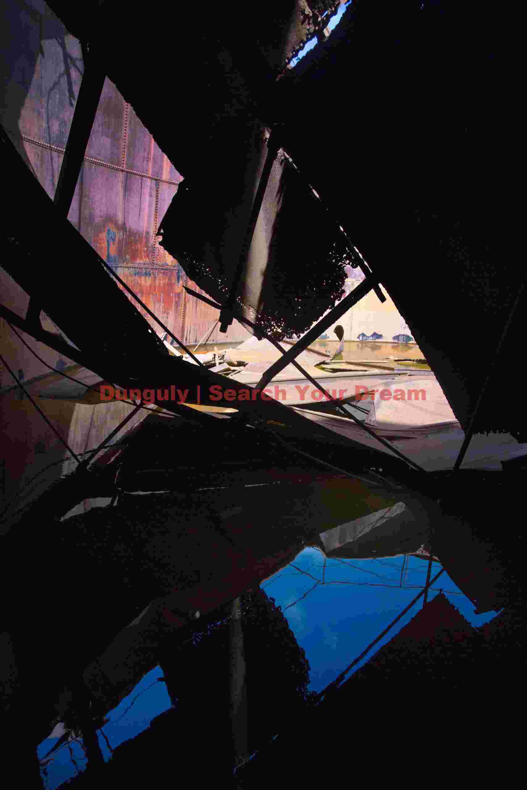 Blue and red sillhouettes inside collapsed tank; Grytviken, South Georgia Blue and red sillhouettes inside collapsed tank