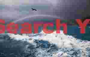 Breaking wave below rainbow