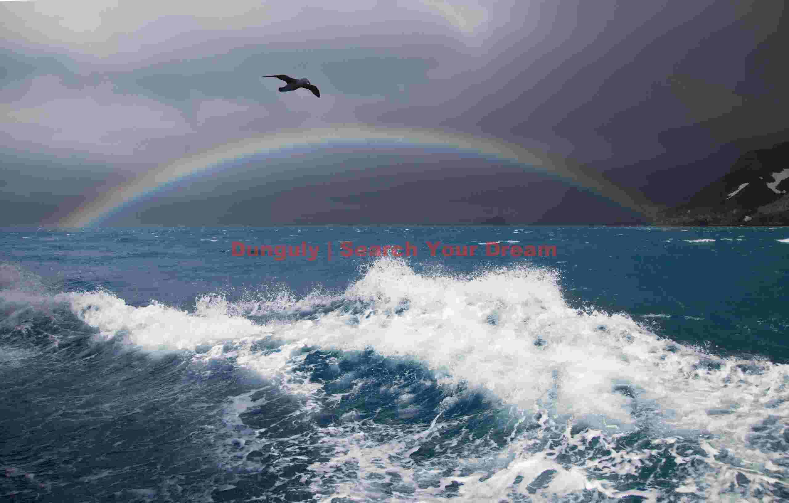 Breaking wave below rainbow; South Georgia Breaking wave below rainbow