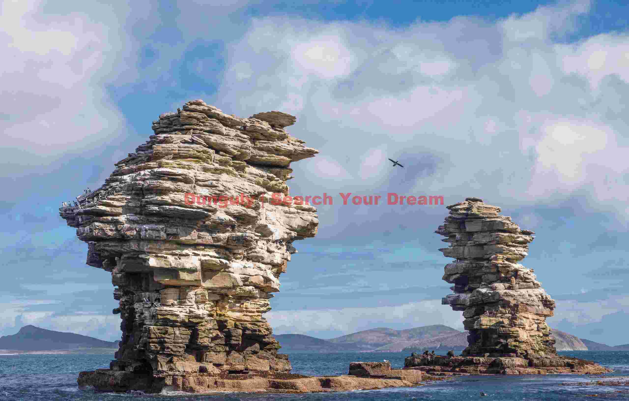 Rock stacks approaching New Island, Falkland Islands Rock stacks approaching New Island, Falkland Islands