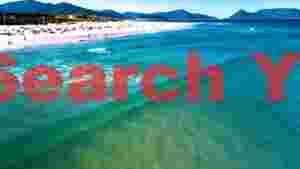 vibrant tropical beach day with crystal waters & mountains