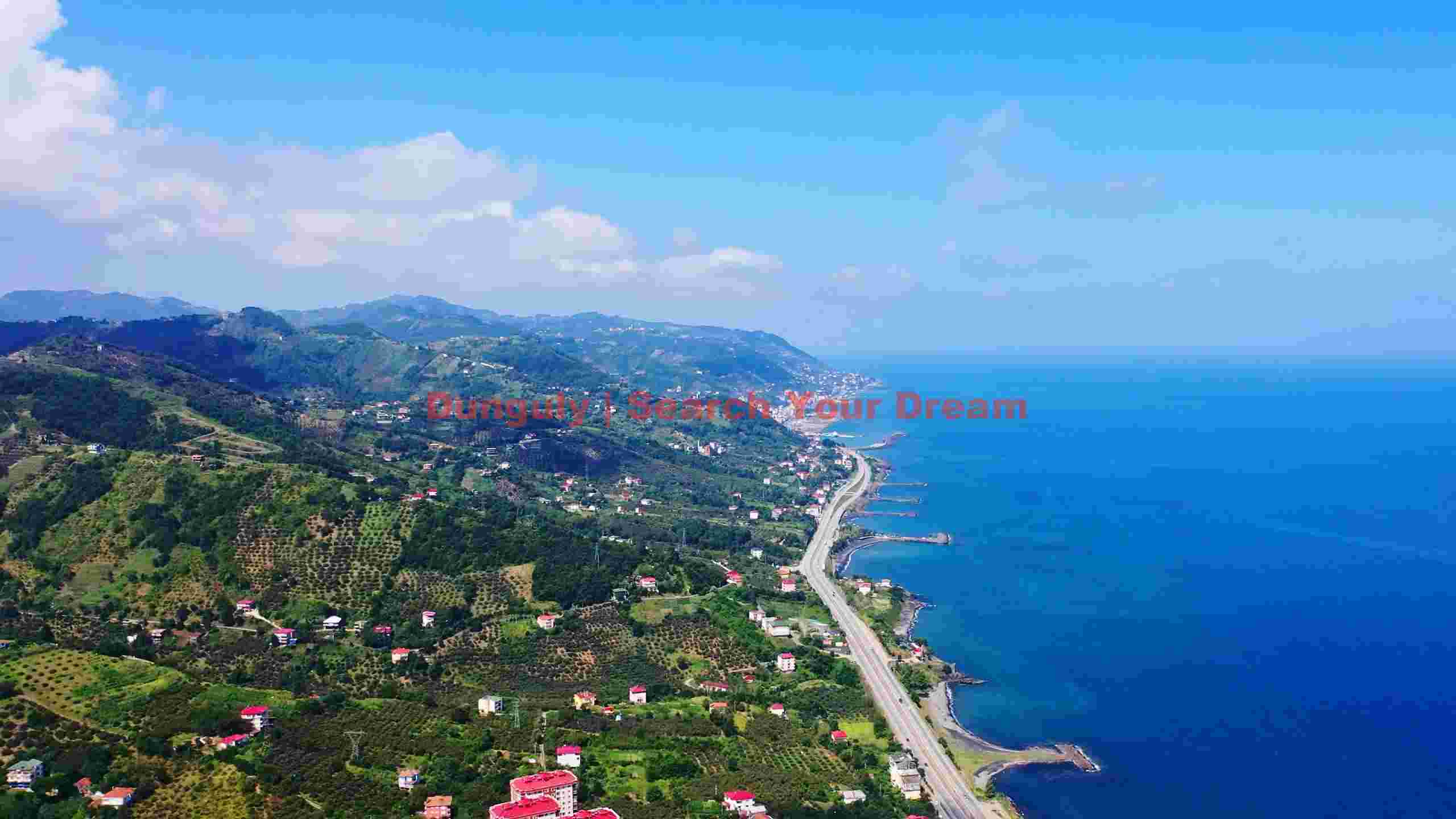 stunning aerial view of coastal highway and lush hills stunning aerial view of coastal highway and lush hills