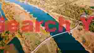 aerial autumn river landscape with suspension bridge