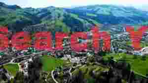aerial panorama of alpine valley town