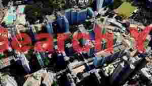 At Home aerial perspective dense urban cityscape with green amenities